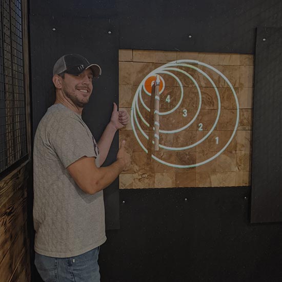 man standing next to bullseye target