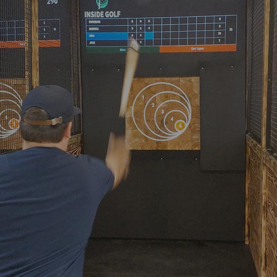 man throwing an axe down the axe throwing lane