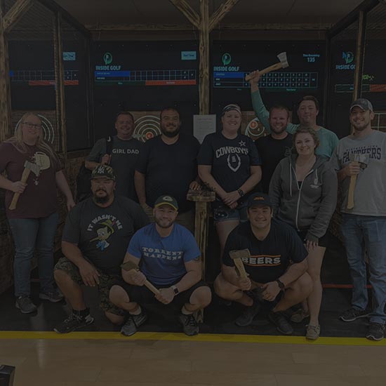 A large group of people having an axe throwing event in Ames