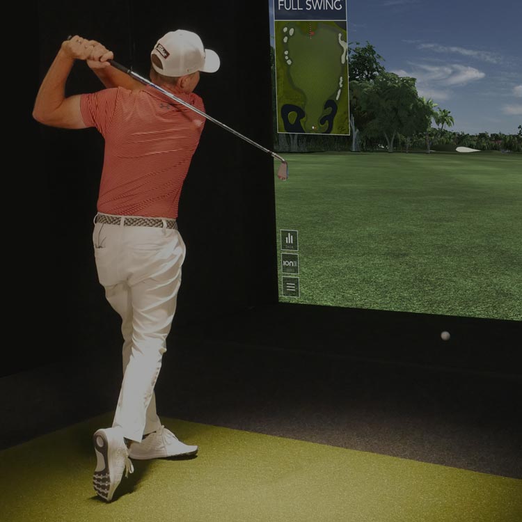 Man swinging golf club on Ames Golf Simulator