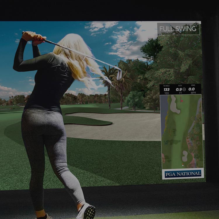 Female playing on golf simulator