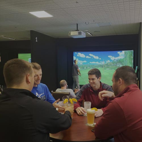 Friends drinking beer at Inside Golf