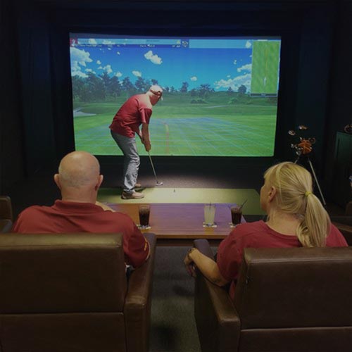 Friends get together for a round of golf at Inside Golf in Ames